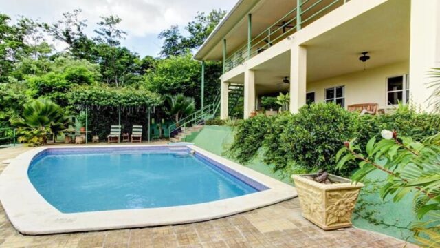 Exterior view of Green Acres Hewitt Home & Guest House surrounded by lush greenery in Hewitt, Texas