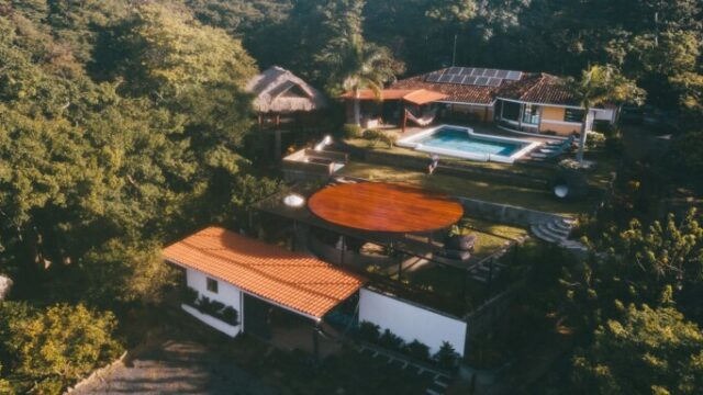 Sunset view from Todo Bien Nicaragua overlooking the Pacific Ocean and lush jungle landscape.