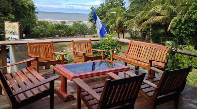 Hostal and Restaurant at Villa Mar exterior view with beachfront setting, colorful facade, and shaded outdoor dining area in San Juan del Sur