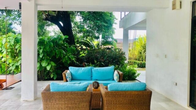 View of Villa Escondida through a covered area to green views beyond – Luxury villa with panoramic bay views in San Juan del Sur, Nicaragua