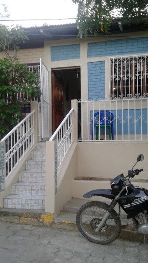 Exterior view of Lorena Surf Hostel showcasing its vibrant facade in San Juan del Sur, Nicaragua