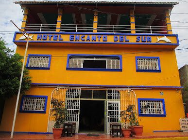 Photo of front of orange buidling Hotel Encanto del Sur