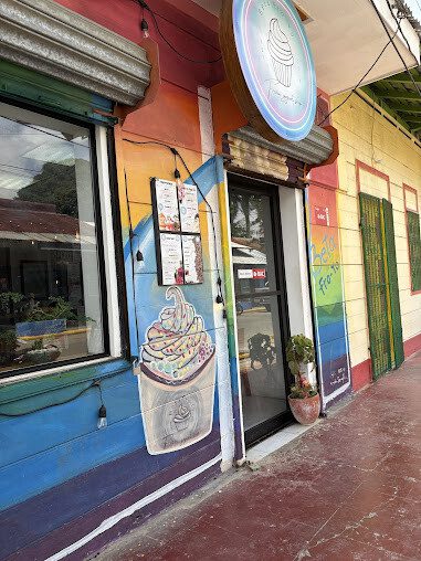 Exterior of Beta Fro-Yo showcasing a variety of frozen yogurt flavors and toppings in San Juan del Sur, Nicaragua