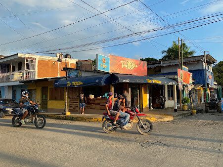 Exterior view of Tío Milton Bar showcasing vibrant decor and lively atmosphere in San Juan del Sur, Nicaragua
