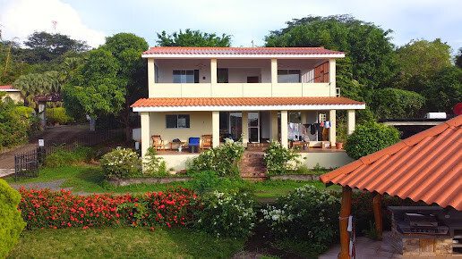 Surf lesson at Beyond the Dream Surf House with pool and jungle backdrop