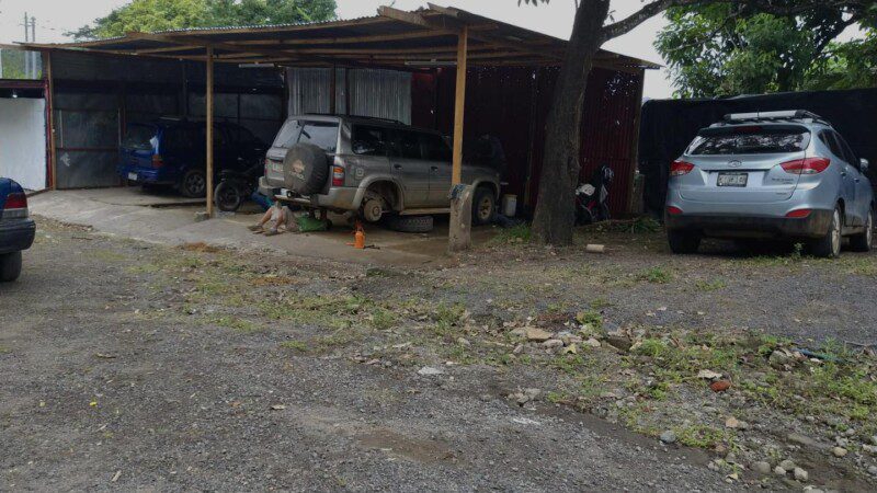 Technician servicing a car at One Stop Auto Shop SJDS in San Juan del Sur, Nicaragua