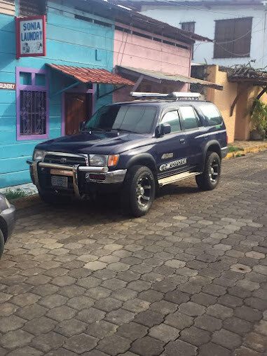 Dayanna Rent a Car & Activities white 4×4 vehicle on road in San Juan del Sur