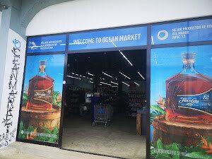 Shelves at Ocean Market San Juan del Sur featuring fresh fruits, vegetables, imported snacks, beverages, and household essentials