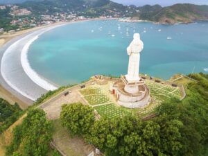 San Juan Del Sur Bay, Nicaragua, aerial image of the famous Jesus statue looking down over the bay: