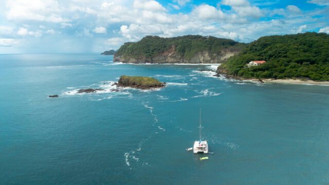 Shot of Santana Sail Yacht with Island Ahead