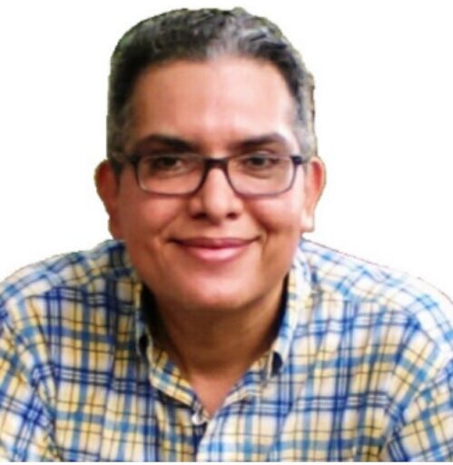 Computer and mobile phone repair technician Carlos Mora fixing laptop and phone