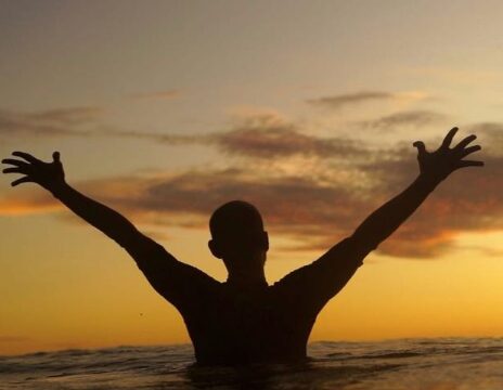 Artist Usumat Kawahe creating a mural and custom sign with paintbrush and creative tools